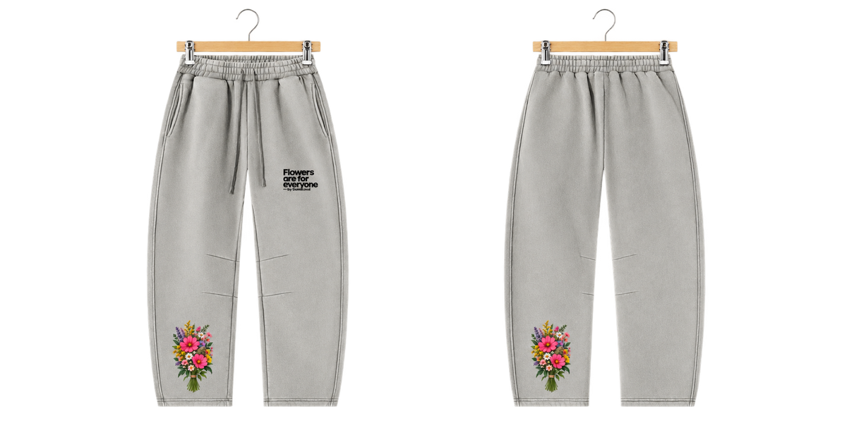 Everyone Loves Flowers Sweatpants on metal clip hanger